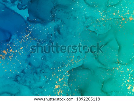 Modern abstract luxury background design or card template for birthday greeting or wallpaper or poster with turquoise  blue watercolor waves or fluid art in alcohol ink style with golden splashes. Royalty-Free Stock Photo #1892205118