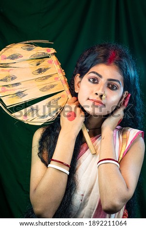 Portrait of   black haired Indian brunette woman with wearing  traditional cotton Saree  and posing