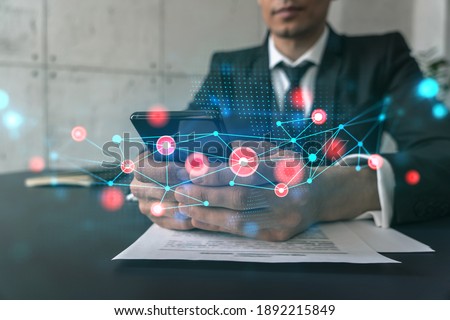 Man in office working with Smartphone, Searching for new tech. Abstract technology hologram, typing phone. Double exposure.