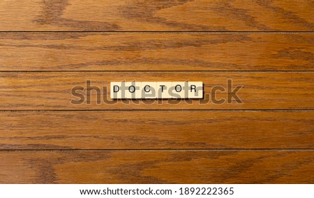 Doctor concept word written on blocks on wood table