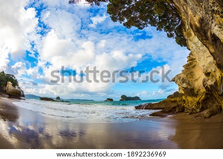 Ocean inflow begins at sunset. The fantastic Cathedral Cave on the sandy beach. Pacific Coast of New Zealand. The concept of exotic, ecological and photo tourism