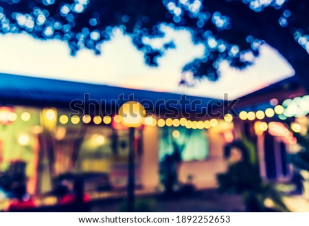 Vintage tone abstract blur image of Shopping mall center in night time with light bokeh for background usage .