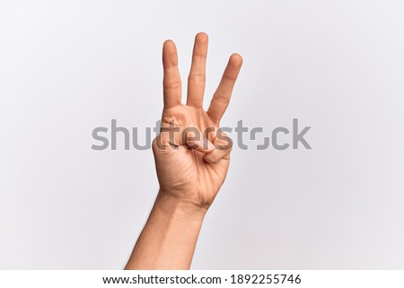 Hand of caucasian young man showing fingers over isolated white background counting number 3 showing three fingers Royalty-Free Stock Photo #1892255746