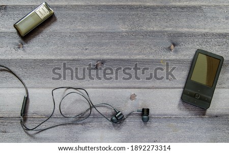 Music player and headphones on the table. Photophone with music
