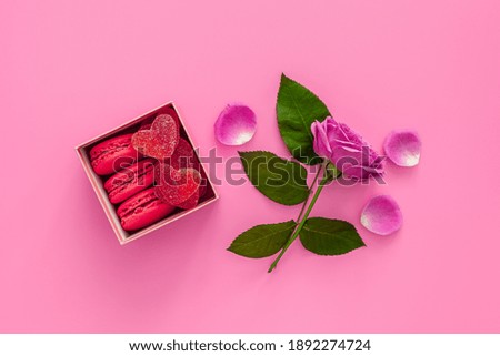 Festive composition for valentine's day and mother's day. Pink rose, box with macaroons 