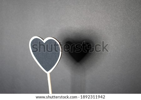 Writing board in heart shape on color background. Wooden panel. Valentines day ideas