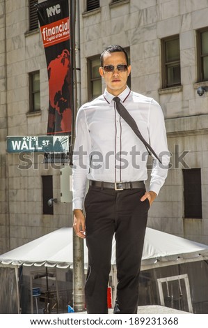 Businessman on Wall Street. Dressing in a white shirt, a black tie, black pants, wearing sunglasses, a hand putting in pocket, a young handsome man is standing on street, confidently looking forward.