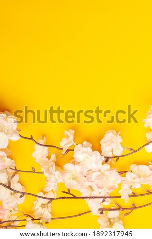 bouquet of pink flowers at the bottom on a yellow background