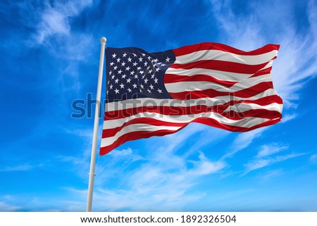 Flag of United States of America being waved in the breeze against a sunset sky.. US flag Royalty-Free Stock Photo #1892326504