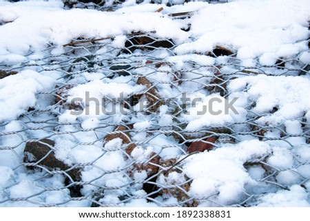 Gabion BOX. Iron mesh covered with snow