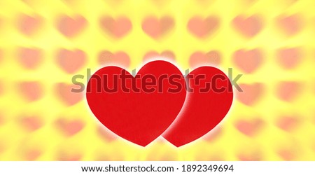 Photo of two hearts on a yellow abstract background