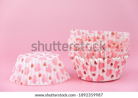 empty pink cupcake mold with hearts on a pink background. Valentine's Day