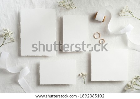 Vintage wedding invitations template. Top view blank paper cards, ribbon, golden rings. Wedding stationery set.