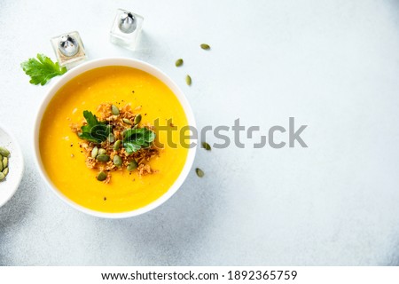 Homemade creamy pumpkin soup with pumpkin seeds