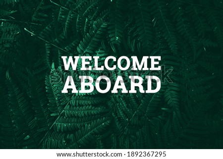 White inscription: welcome aboard, on a green natural background. Concept for motivating background, business, self-development