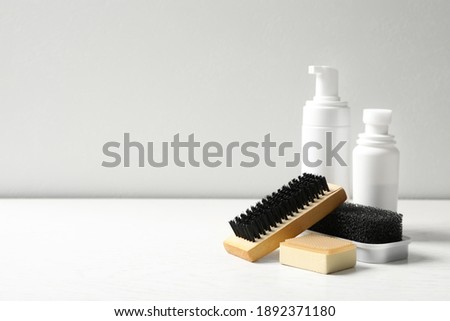 Composition with shoe care accessories on white table, space for text Royalty-Free Stock Photo #1892371180