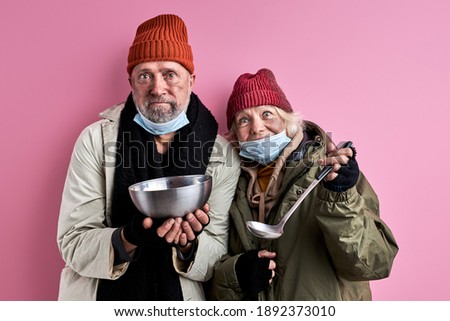elderly beggars man and woman ask food donation, holding iron bowl in hands, need food for surviving