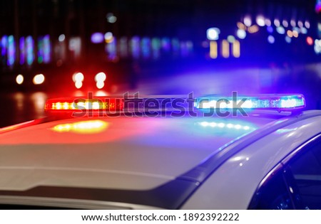 police car lights at night in city with selective focus and bokeh
