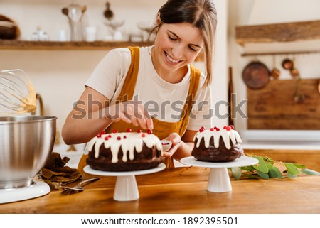 Caucasian smiling pastry chef woman making chocolate cake at cozy kitchen Royalty-Free Stock Photo #1892395501