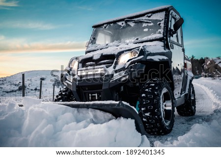 The winter has arrived, and today i was snow plowing my driveway with my ATV. Beautiful sky in the background. Royalty-Free Stock Photo #1892401345