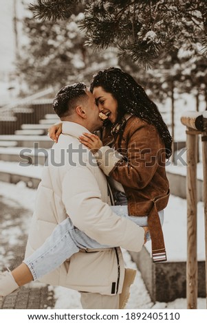 Beautiful Couple In Love kissing and laughing. Amazing winter holiday. Saint Valentine's Day.