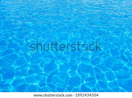 Sunny abstract blue water background. Mobile photography of rippling waterpool