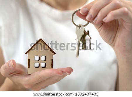 the key to your own home in the palm of the girl and a wooden ho