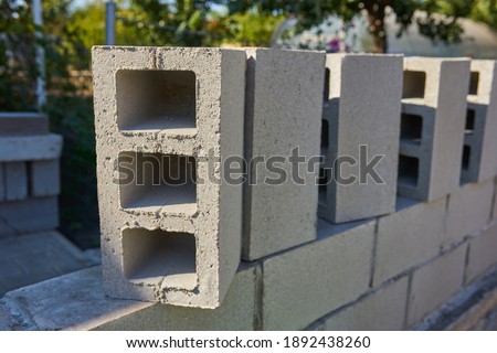 a worker builds a cinder block wall for a new home Royalty-Free Stock Photo #1892438260