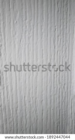 The texture of wood painted in white, vertical picture background of wood in white.