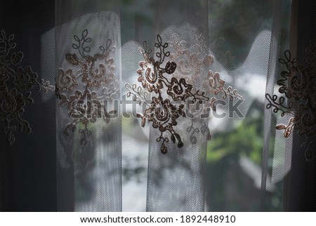 a curtain as visual protection in front of a window