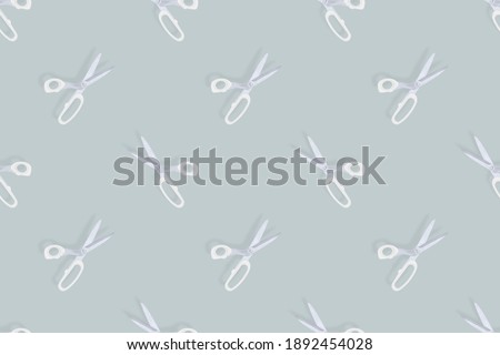 Scissors seamless pattern. Barber scissors against gray background backdrop.