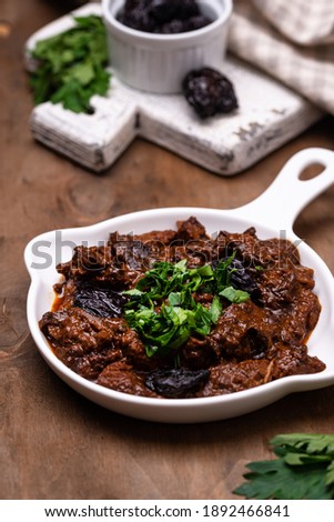 Stewed meat with prunes. Hot autumn or winter dish