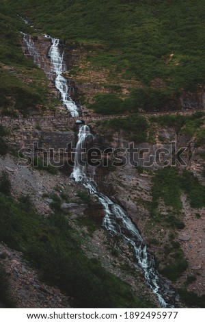 Aster Falls Tumbles Over Cliff and Under Going to the Sun Road in Glacier National Park