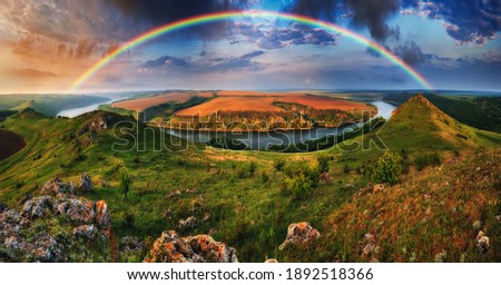 colorful rainbow over the river canyon. spring morning