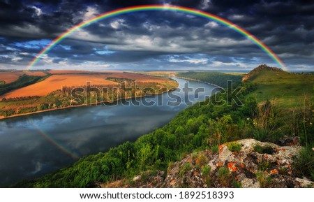 colorful rainbow over the river canyon. spring morning