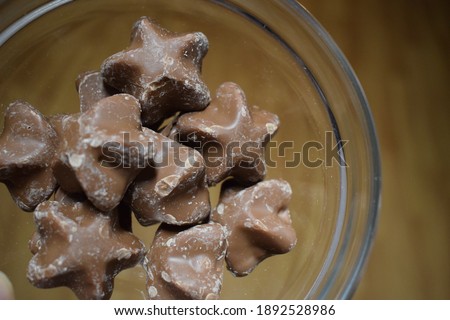 caramel filled chocolate stars holidays special christmas snacks in a glass bowl