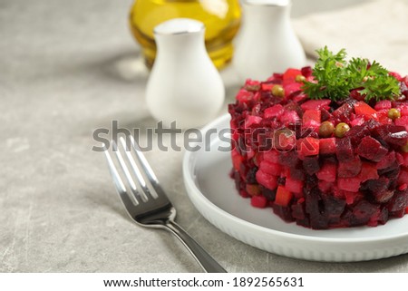 Traditional Russian salad vinaigrette served on light grey table, closeup. Space for text