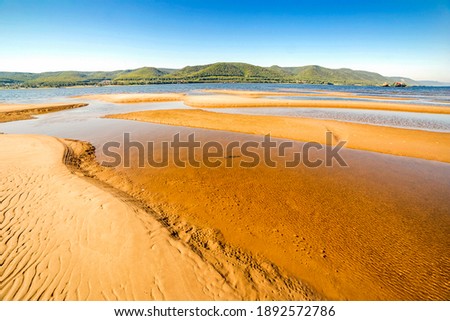 beautiful sandy beaches shallows on the Volga river against the background of the Zhiguli mountains on a summer sunny day