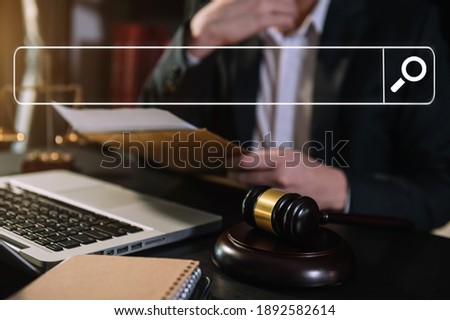  Business and lawyers discussing contract papers with blank search bar.justice and law concept.Male judge in a courtroom