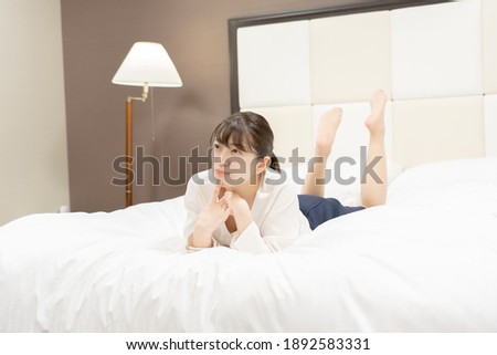Asian woman relaxing in bed