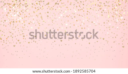 Gold flying hearts on pink background. Glistening gols falling hearts.