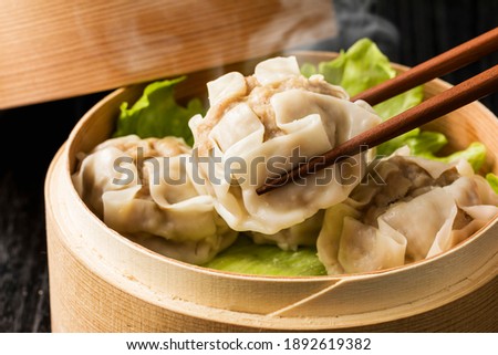 Meat dumpling in bamboo steamer Royalty-Free Stock Photo #1892619382