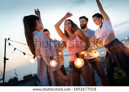 Having a great time with friends, having fun at rooftop party Royalty-Free Stock Photo #1892677018