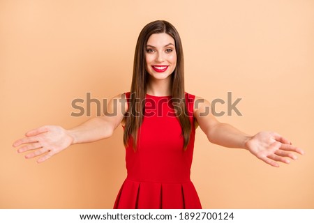 Photo of stunning pretty lady open hands welcome you good mood nice smile isolated on pastel beige color background
