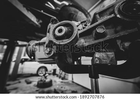differential on a stand. Transfer of rotation to the rear wheels. Maintenance and repair. Oil seals, rods and splines. 4 wheel drive off-road vehicle SUV. Vehicle on a lift. Black and white