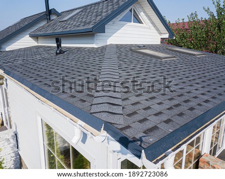 Shingles texture - close up view of asphalt roofing shingles Royalty-Free Stock Photo #1892723086