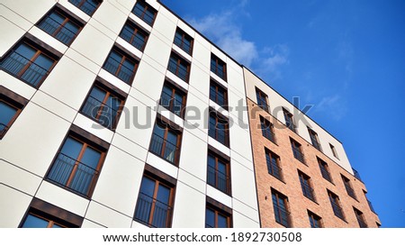 Fragment of modern luxury residential apartment,  home house building concept. Modern apartment building on a sunny day with a blue sky.