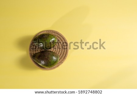 Avocado fruit isolated on yellow background for multiple uses, large file
