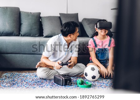 Portrait of enjoy happy love asian family father and little asian girls child smiling and having fun using glasses of virtual reality headset.concept of modern technologies