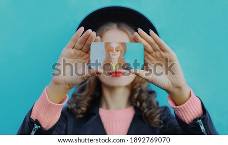 Close up of woman stretching her hands taking selfie picture by phone over a blue background